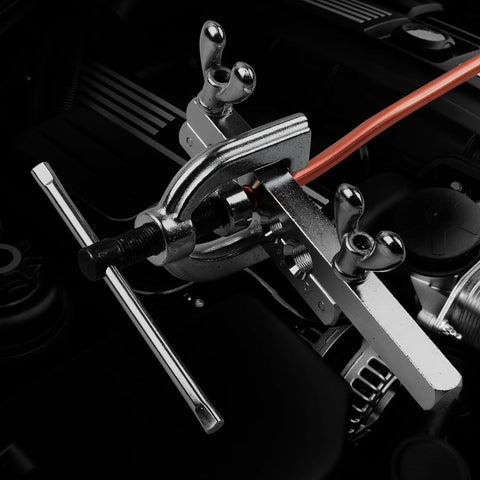 Brake line flaring tool kit clamped to orange copper tubing in engine bay (close-up)
