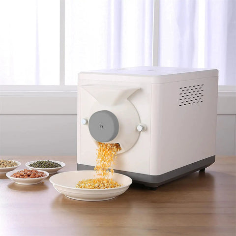 Automatic Coffee Bean Roaster With Nonstick Electric Pan For Peanuts Cashews And Chestnuts Featuring Adjustable Heat And Timer Knobs For Smooth No Sweat Home Roasting Top Shelf Results, with roasted seeds flowing into a dish.