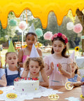Children at a birthday party with a cake and Bee Themed Diamond Painting Coasters Kit With Holder Eight Pattern Coasters.