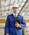 Engineer in blue uniform holding document bag on construction site. Visible: Two Size Fireproof Waterproof Document Bag Set 13.4x9.8 And 10.6x6.7 With Reflective Strip Zippers For A4 Files, Cash, Passport, Jewelry, Photos, And Important Docs, Heavy Duty Safe Storage Organizer Pouch.