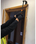 Person using Heavy Duty Indexing Crowbar And Nail Puller Wrecker Tool for yanking baseboard trim during demolition.
