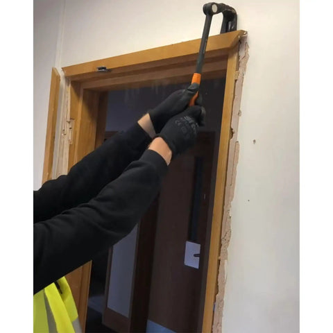 Person using Heavy Duty Indexing Crowbar And Nail Puller Wrecker Tool for yanking baseboard trim during demolition.