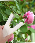 Hand holding Rose Thorn Remover Tool And Leaf Stripper For Roses Burrs Removal For Gardening DIY Floral Art Home And Flower Shop Use Easy Thorn Cleanup And Pruning on pink rose stem
