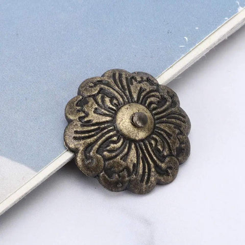 30 Piece Retro Zinc Alloy Upholstery Tacks And Furniture Nails 22mm Round Heads With 10mm Shank For Sofa Chair Bed DIY Makeovers To Snag Quick Fixes And Level Up Your Home Digs Today decorative bronze tack with floral design on fabric surface.
