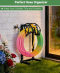Heavy Duty Freestanding Garden Hose Reel Stand With Ground Spikes Detachable Metal Rack holds colorful hose next to flowers