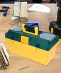 Heavy Duty Plastic Handheld Toolbox With Rugged Ergonomic Handle For Storing Hardware And Gear Making The Daily Grind Easy Around The Home Garage Or Job Site on workbench with tools.