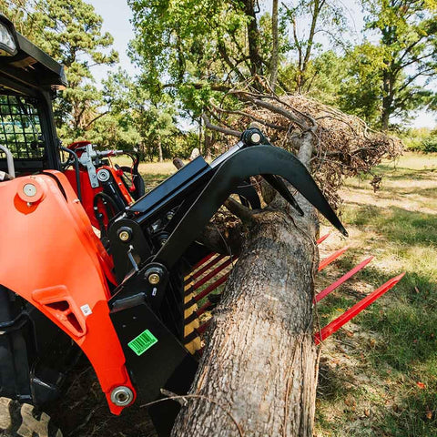 72 Inch Manure Tine Grapple Bucket Attachment With SSQA Hay Spear Frame lifts log, showcasing double grapple rake arms in action
