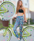 Woman riding a green bike decorated with Plastic Bike Spoke Beads Set With 7 Styles In Assorted Colors, about 280 pcs on wheels.