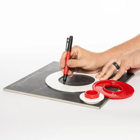 Person using Tile Drilling Template And Guide With Four Interlocking Rings For Precise Tile Holes on a black tile surface