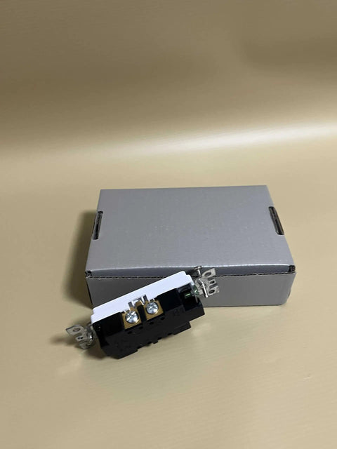 Kickass Heavy Duty 20 Amp Decorator Wall Outlet Socket next to its packaging on a plain background.
