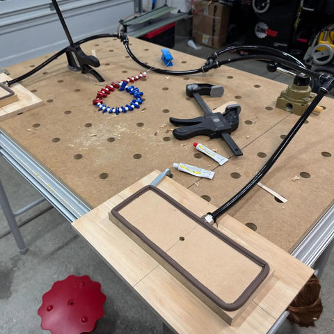 Workhorse 1/2 Inch PU Pneumatic Tubing setup on workshop table with tools and fittings for air compressor installation