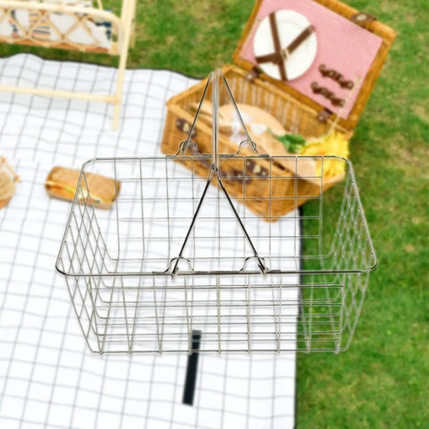 Heavy Duty Iron Shopping Basket With Cushioned Ergonomic Handle Straight Up Durable Grocery Tote For Home Market And Kitchen Runs No Sweat Heavy Load Errand Caddy hanging above a picnic setup.