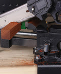 Image of Industrial Grade Rock Solid Heavy Duty 6 Inch Bench Vise With All Steel Swivel Base And Dual Jaw Design holding wooden block.