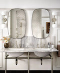 Colinet Traditional 24-Inch Towel Bar in Brushed Nickel mounted in elegant bathroom with dual mirrors and marble sinks.