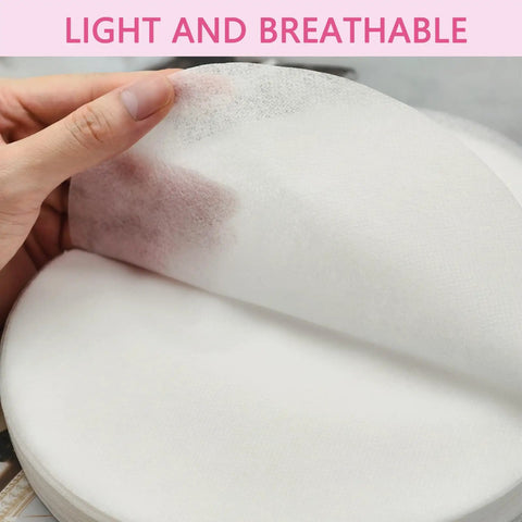 Hand holding lightweight sheet from 200 Sheets Disposable Nail Dust Filter Papers for Most Nail Dust Collectors and Vacuums.