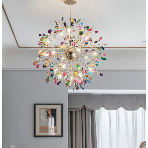 Colorful sputnik chandelier with leaf-like crystals hanging in a modern living room setting.
