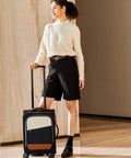 Front view of LoveVOOK carry-on rolling suitcase with extended handle; navy body, cream front panel, brown base.