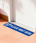 Five Piece Please Wait Here Floor Sign Kit 26 By 6 Inches Self Adhesive Waterproof Vinyl, Durable Social Distancing Markers For Queues And Waiting Areas, Multipack Signage For Busy Shops. Blue floor sign on tiled floor near a door