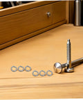 Tough As Nails Stainless Steel Spring Lock Washers M10 Split Ring Kit 100 Pieces with bolts and screws on a workbench.