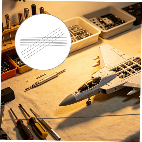 10 Pack Carbon Fiber Round Rods For RC Models near RC plane model on workbench with tools and parts