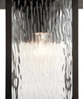 Close-up of Capanna 1-Light Outdoor Wall Light in Olde Bronze with clear water glass showing unique ripple pattern.