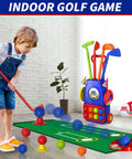 Child playing with Tot Friendly Mini Golf Toy Set With Golf Cart, Putting Mat, 4 Clubs and 8 Balls For Backyard Play.