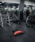 Arm Curl Isolator Training Aid with Upper Arm Stabilizer and Adjustable Strap in a gym setting, emphasizing cleaner bicep form.