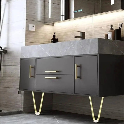 Modern bathroom vanity with V shaped metal furniture legs and marble countertop