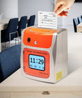 No Sweat Contactless Time Clock For Small Business Automated Payroll Tracker With Hands Free Drop In Card Slot Plug And Play Hygienic Shell Rock Solid Performance on a desk with a hand dropping a card in.