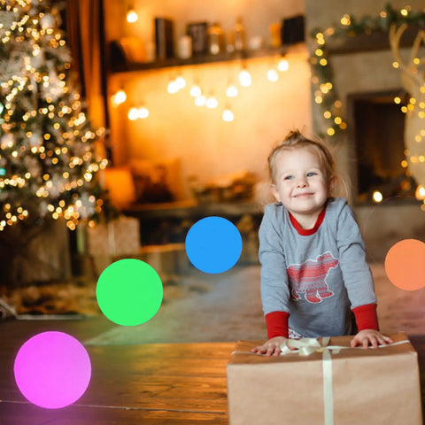 LED Glowing Ball Light Cordless 8 Inch With 16 Color Changing Options and child in cozy holiday setting