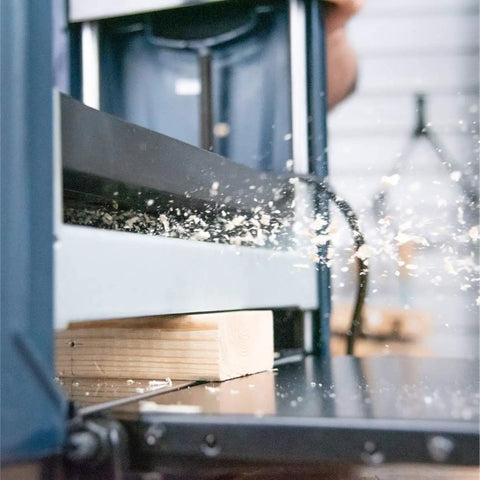 Smooth As Glass 15 Amp Benchtop Thickness Planer in action, smoothing rough lumber with dual hardened steel cutters.