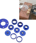 Tough As Nails 10 Piece Aluminum Alloy Router Template Guide Bushing Set with blue aluminum bushings and heavy duty lock nuts laid out on wood.