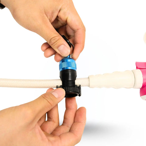 Hands attaching Blue Magnetic Regulator Octo Hose Holder Clip For Scuba Gear to hose, demonstrating easy deployment.