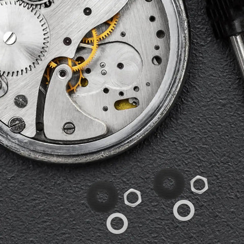 Go-To Clock Washer Set With Nuts And Rubber Rings, 20-Piece Metal Kit For Easy DIY Clock Repair And Mechanism Replacement, Durable Antiaging Materials For Lasting Performance. Clock mechanism and spare nuts, washers, rubber rings on dark surface.