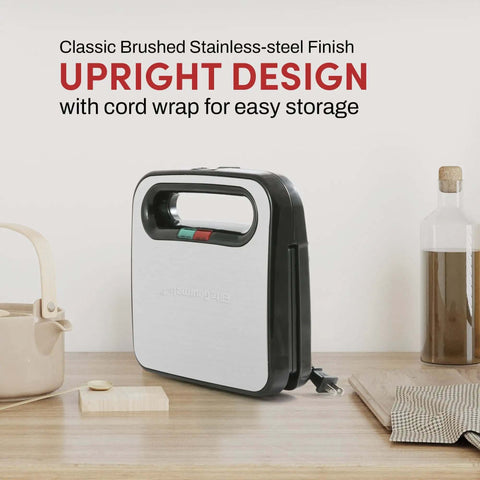 Upright Go-To Panini Maker Grill Press For Quick Grilled Cheese And More 2 Slice, 750 Watt Stainless Steel on a countertop.