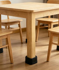 Wooden table and chairs with anti-vibration pads for heavy duty floor protection and noise reduction.