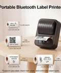 Awesome Bluetooth Label Maker Machine Printing On White Color Clear Thermal Labels With Tape For Home Business Organization Crisp Graphics No Ink Needed 2 Inch Wide Portable Handy Tech Gadget on a wooden table with various labels.