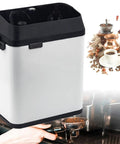 No Sweat Automatic Portafilter Cleaner And Knock Box For 58mm Espresso Filter Holders, heavy duty chute in use with coffee grounds.