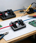 Heavy Duty Wire Soldering Clamp Holder For Welding Projects Wire Wiring Fixture Bracket Soldering Board on a workbench with tools