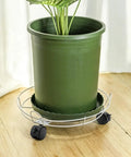 Four Pack 1.5 Inch Swivel Caster Wheels With Locking Brakes And 6.25 Millimeter Straight Stem For No Sweat Swap on green plant pot.
