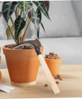 Multipurpose Manganese Weeding Scythe With Comfortable Handle beside potted plant on table