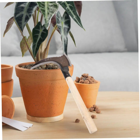 Multipurpose Manganese Weeding Scythe With Comfortable Handle beside potted plant on table
