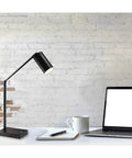 Colby Adjustable Desk Lamp With 15.5 To 32.5 Inch Reach 9W Integrated LED on desk with laptop and notebook in home office setting.