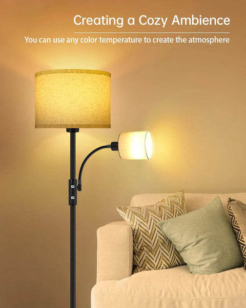 Gold Tone Floor Lamp With Dimmable 9W LED Main Light And 4W Reading Lamp illuminating a cozy living room corner with beige linen shade.