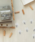 100 Pack Shelf Pegs For Wardrobes And Cabinets with plastic and stainless steel pins, shown with cabinet tools on wooden surface.