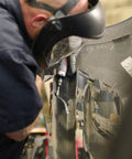 Person using Beast Power Air Die Grinder With 25,000 RPM And 0.4 HP, 1/4 Inch Collet on auto part in workshop setting.