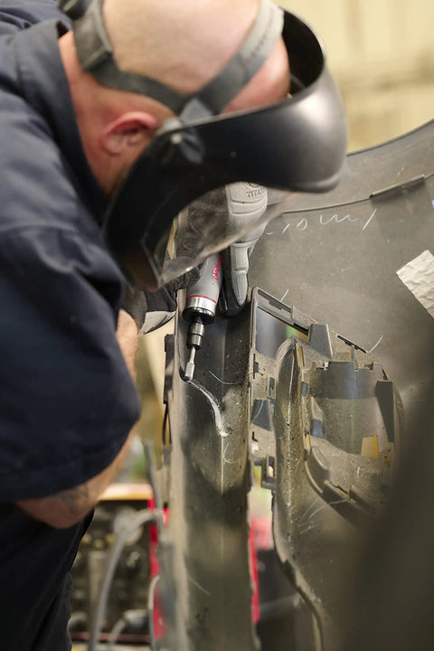 Person using Beast Power Air Die Grinder With 25,000 RPM And 0.4 HP, 1/4 Inch Collet on auto part in workshop setting.