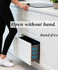 Person demonstrating 16 Pack Magnetic Cabinet Door Latches Heavy Duty Drawer Catches Push To Open in a kitchen setting.