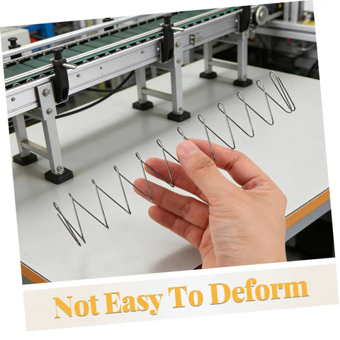 Hand holding Two Pack Industrial Trapezoidal Flat Compression Springs 1x9.5x35x160mm against machinery background