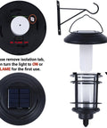 4 Pack Solar Powered Flame Wall Lanterns Outdoor Waterproof Sconce Lights with battery compartment and mounting bracket.